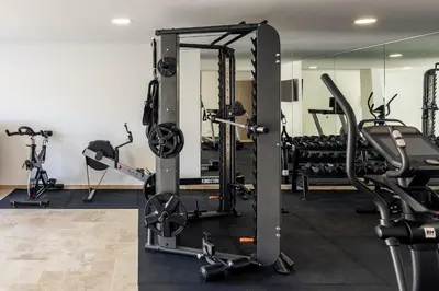 a gym with several treadmills and exercise bikes at Faro Luxury Home with Heated Pool and Garden in Faro