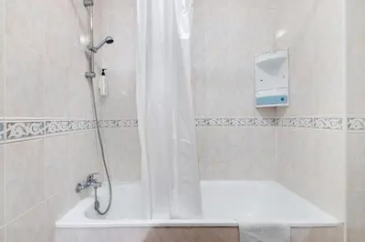 a bathroom with a shower and a bath tub at Apartamento 16 - Quarteira in Quarteira