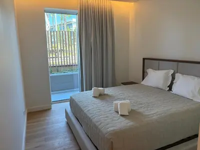 a bedroom with a large bed and a large window at Quarteira Horizon Sea in Quarteira