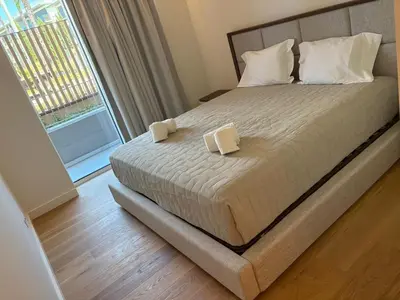 a bedroom with a bed with two pillows and a window at Quarteira Horizon Sea in Quarteira