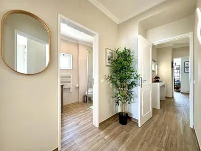 a hallway with a mirror and a potted plant at Quarteira Central Beach 5 by Homing in Quarteira