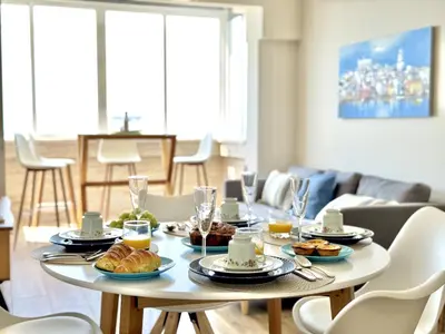 a table with food on it in a living room at Quarteira Central Beach 5 by Homing in Quarteira