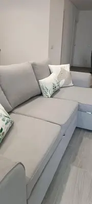 a white couch with pillows on it in a room at Skynest 59 Faro Airport Guest House in Faro