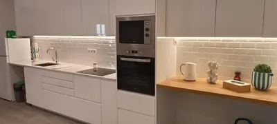 a white kitchen with a sink and a microwave at Skynest 61 Faro Airport Guest House in Faro