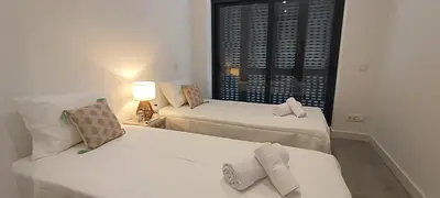 two beds in a room with a window at Skynest 61 Faro Airport Guest House in Faro