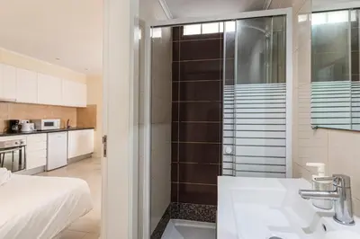 a bathroom with a shower and a sink and a bed at Budget Beach Center - B4 in Albufeira