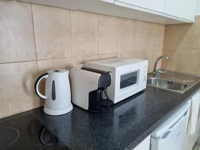 a kitchen counter with a microwave and a coffee maker at Budget Beach Center - B4 in Albufeira