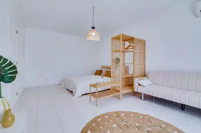 a living room with a couch and a book shelf at Brisa Algarvia 1 in Faro