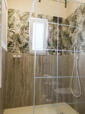a bathroom with a shower with a glass door at Apartamento T1 Luxo Marina Vilamoura in Vilamoura
