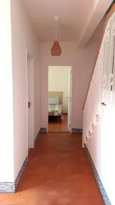 a hallway leading to a bedroom with a bed at Villa UM in Albufeira