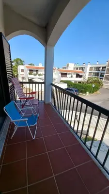 a patio with two chairs on a balcony at Villa UM in Albufeira
