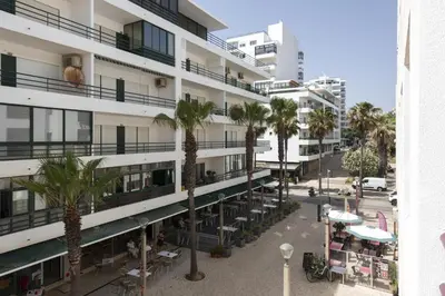 an aerial view of a building with palm trees at Mare Viva - Seafront with pool by HD in Quarteira