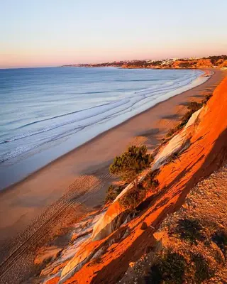 an aerial view of the beach at sunset at 1 Bedroom apt with pool access in Albufeira