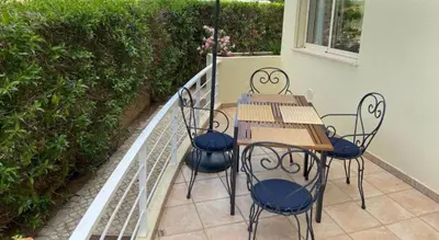 a table and chairs sitting on a balcony at Modern 2BR Vilamoura Stay Pool Access Golf Nearby 15 Percent Off in Quarteira