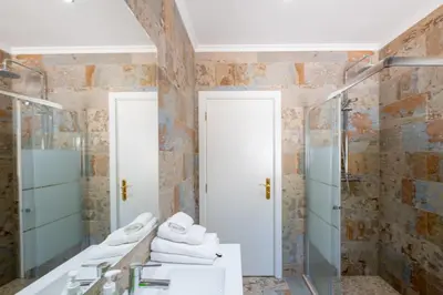 a bathroom with two sinks and a shower at Pedro Mar by Atlantic Places in Albufeira