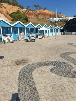 a row of blue houses in a parking lot at Vista das Ondas in Albufeira