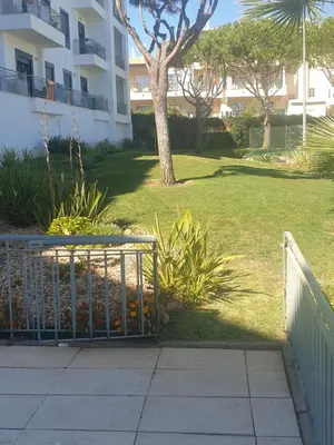 a gate in a yard next to a building at Vista das Ondas in Albufeira