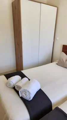 a bed with two towels sitting on top of it at Vista das Ondas in Albufeira