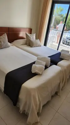two beds sitting next to each other in a room at Vista das Ondas in Albufeira