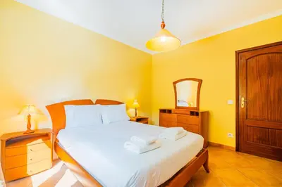 a bedroom with a bed with two towels on it at Retiro dos Calicos by Dreamplaces in Albufeira