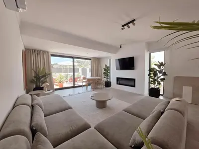 a living room with a couch and a tv at Casa Shiva in Albufeira
