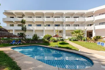 a resort with a swimming pool in front of a building at 1- bedroom flat in Vilamoura near the beach in Vilamoura