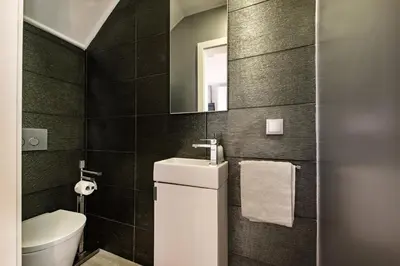 a bathroom with a toilet and a sink and a mirror at Casa dos Quatro in Faro