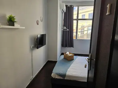 a small room with a bed and a window at Blife Lusitanya - private rooms at Santantonya 1st floor in Faro