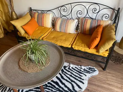 a couch with pillows and a table in a living room at Quinta Oriana Bella suite in Paderne