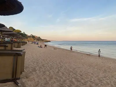 a group of people on a beach with the ocean at Quinta Oriana Bella suite in Paderne