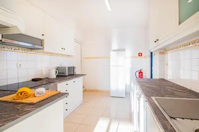 a white bedroom with a white bed and a window at Casa Gale Mar in Galé