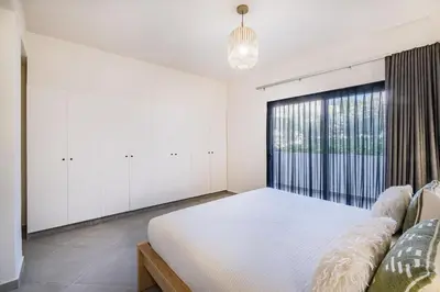a white bedroom with a large bed and a window at Casa Gale Mar in Galé