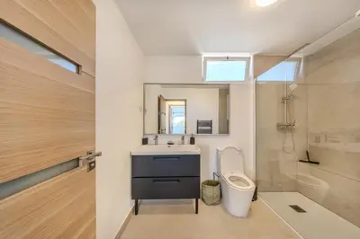 a bathroom with a toilet and a sink and a shower at Quinta Veigas in Medronhal