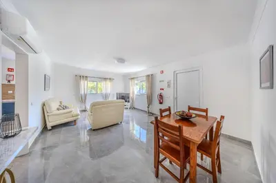 a living room with a table and chairs at Quinta Veigas in Medronhal