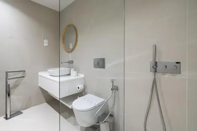 a white bathroom with a toilet and a mirror at Vilamarina Elegance T2 Marina View Vilamoura in Quarteira