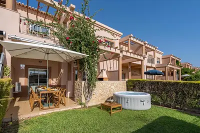 a backyard of a house with a table and an umbrella at Sunny House with Jacuzzi and Pool by HostWise in Albufeira