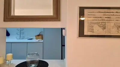 a picture of a kitchen with a table with a glass at Vilamoura Sul CD 312 - Cleverdetails in Quarteira