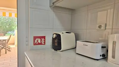a kitchen with a toaster and a toaster on a counter at Vilamoura Sul CD 312 - Cleverdetails in Quarteira