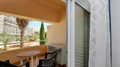 a balcony with a table and chairs and a window at Vilamoura Sul CD 312 - Cleverdetails in Quarteira