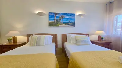 two beds in a room with two tables and two lamps at Vilamoura Sul CD 312 - Cleverdetails in Quarteira