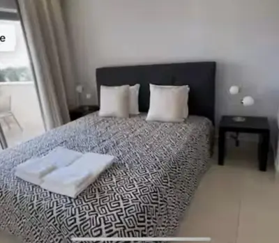 a bedroom with a bed with two towels on it at Pine Hills Vilamoura in Quarteira