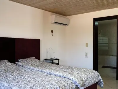 a bedroom with a bed with a pink bedspread at Casa Da Liberdade