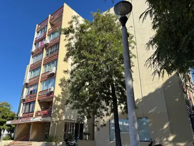 a white building in a city with buildings at Studio Estrelas Vilamoura in Vilamoura