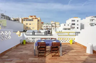 a table and chairs on the roof of a building at Blife Galya private house in Faro