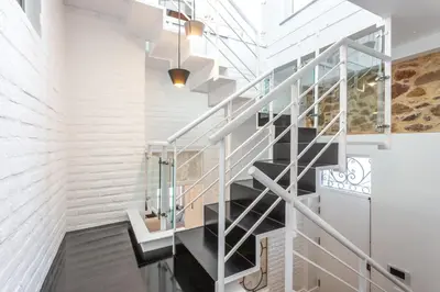a staircase in a house with a glass railing at Blife Galya private house in Faro