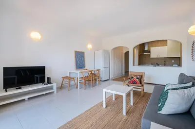 a living room with a couch and a table at Stunning Apartment By Dreamplaces in Albufeira