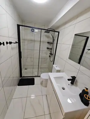 a bathroom with a shower and a sink and a toilet at Santos Studio in Faro