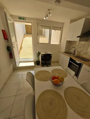 a kitchen with a table with a bowl of fruit on it at Santos Studio in Faro