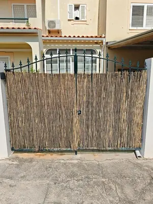 a wooden fence in front of a house at Santos Studio in Faro