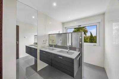 a bathroom with two sinks and a large window at Villa Caripira by Villa Plus in Albufeira